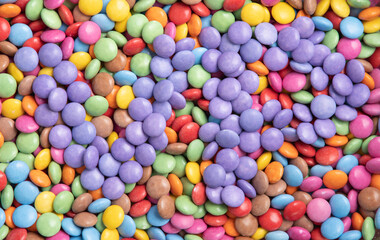 texture of multi-colored candies, the letters of the color of the year very peri