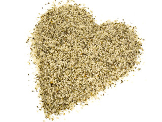 Shelled Hemp Seeds in Heart Shape isolated on white Background