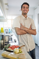 This kitchen is my domain. Portrait of a happy young man posing in his kitchen at home.