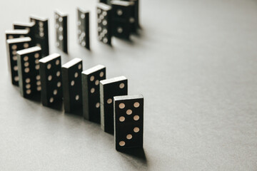 Black dominoes chain on white table background