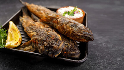 Fried fish Black Sea goby, on a dark background