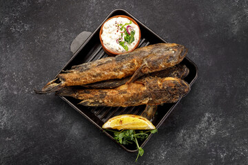 Fried fish Black Sea goby, on a dark background