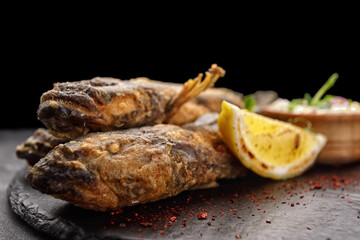 Fried fish Black Sea goby, on a dark background