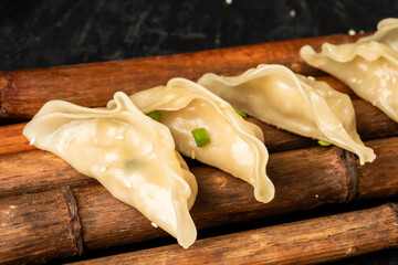Asian dumplings lie on bamboo. Gedza stuffed.