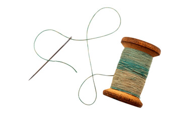 Old retro needle and thread on a white background. Spool of colored threads isolate