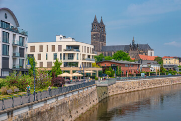 View over new modern houses at historical downtown in Magdeburg at Elbe river bank, Germany, at blue sky and sunny Spring day. - obrazy, fototapety, plakaty