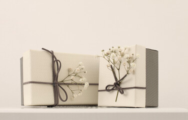 Craft empty gift boxes with flower twig on beige copy space horizontal  background.