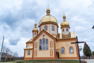 Fototapeta na wymiar Christian Orthodox church with golden domes in Ukraine. Example of Christian Orthodox religious architecture
