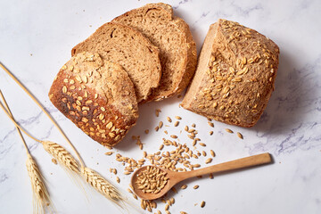 Fresh loaf of homemade sourdough rye bread in slices.
