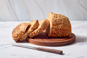 Fresh loaf of homemade sourdough rye bread in slices.