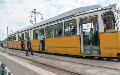 Riders enter a streetcar at a stop in Budapest Hungary.