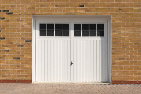 Classic look, white side hinged garage doors, on a new build home.  UK