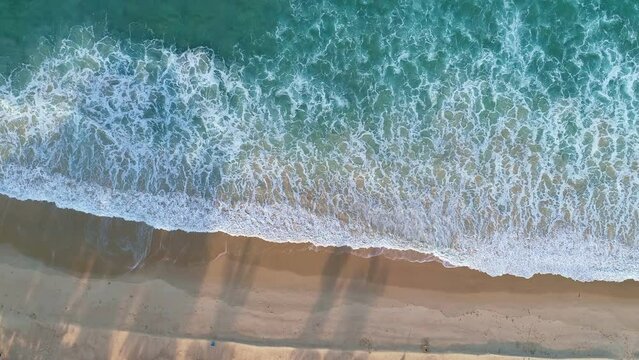 Aerial view of Phuket sea and sand beach in summer season. Amazing sea beach with ocean wave foams. Beautiful nature seascape of sea surface. Concept holiday summer Travel destination