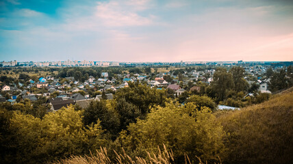 Evening sunset with a view of the village and the city in warm weather in the summer near the Dnieper
boulevard in Mogilev, Belarus.