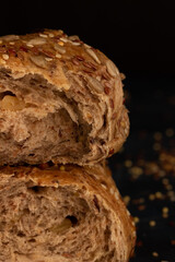 Cereal bread is on the table, dark background