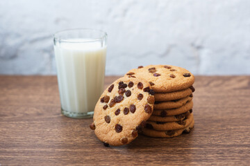 Fragrant, tasty, homemade cookies with raisins and a glass of fresh milk on the table