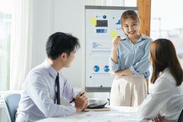 three business team in a meeting or conference room talking about a economy or succes diagram in the offiice and one of them with red hairs phone paralell with a customer or other a department