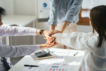 Happy asian businesspeople giving high five, close up focus on people hands. Friendly multiracial...