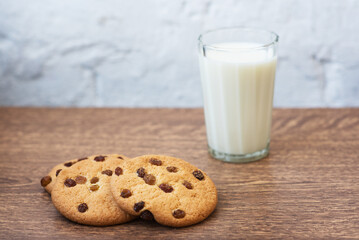 Fragrant, tasty, homemade cookies with raisins and a glass of fresh milk on the table