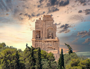 A fiery sky over Philopappos monument hill during sunrise, Athens, Greece