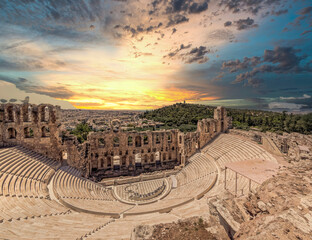 Fiery sky over Herodion ancient theater and Athens city panoramic view during sunrise, Greece