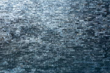 Black brick wall with gradient sunlight by top left to bottom right. Can used for background.