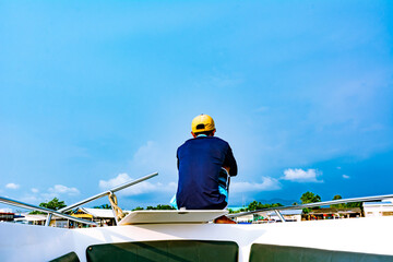 Crew boat siting on prow boat. Lonely and sad because no tourist. Covid-19 side effects concepts.