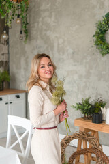 Beautiful happy woman with flowers indoors 
