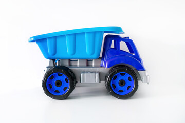Colorful large blue plastic dump truck, tip lorry, car toy isolated on white background mockup with copy space, toys for children, kids development, playing, childhood fun