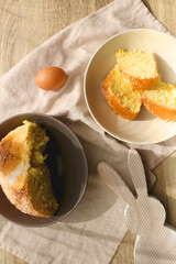 Plate of traditional sweet bread, eaten at Easter time in Croatia. Easter bunny, eggs and flowers on the table. Top view.