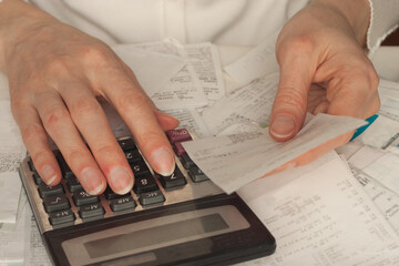 The woman checks the bills.