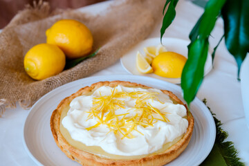 Lemon tart. Shortcrust pastry with lemon cream and whipped cream. Baked lemon pie.