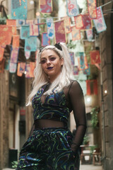 Fototapeta premium Confident alternative woman looking at camera while posing outdoors on the street.