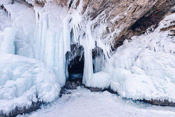 Blue ice cave grotto lake Baikal Olkhon island, Russia. Frozen clear icicles, beautiful winter landscape