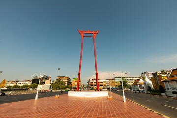 Bangkok, Thailand - MARCH 17,2022 : Sao Ching Cha (Giant Swing) with Wat Suthat temple and old...