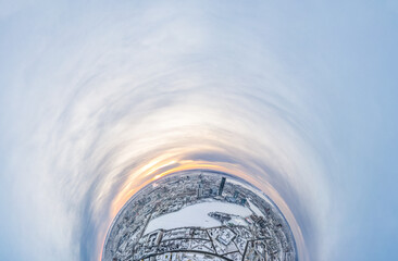 Aerial winter city view with crossroads and roads, houses, buildings, parks and bridges. Copter...