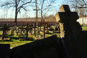 Stone and wooden crosses in an old Catholic cemetery in the village of Owinska