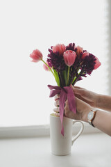 cozy spring home decor with a pink tulip bouquet in daylight. Spring stll life, birthday, Easter concept