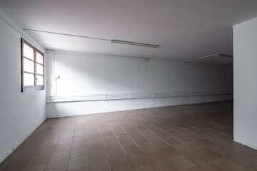 empty room of a warehouse in white color with a window