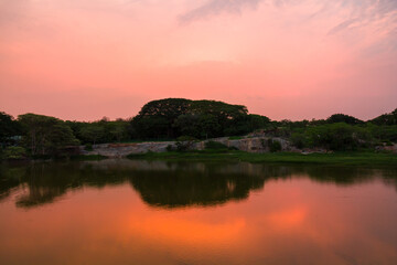 Colorful sunset,mackerel clouds,reflections in water in Lalbagh Lake,Bangalore or Bengaluru.Lalbagh...