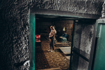 Plakat War in Ukraine. A Ukrainian pregnant woman hides in a bomb shelter while resisting a Russian invasion.