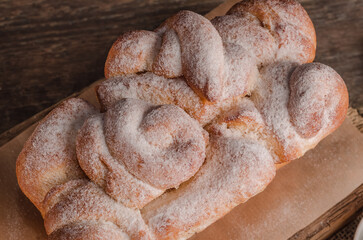 Beautiful loaf of white bread on wooden background