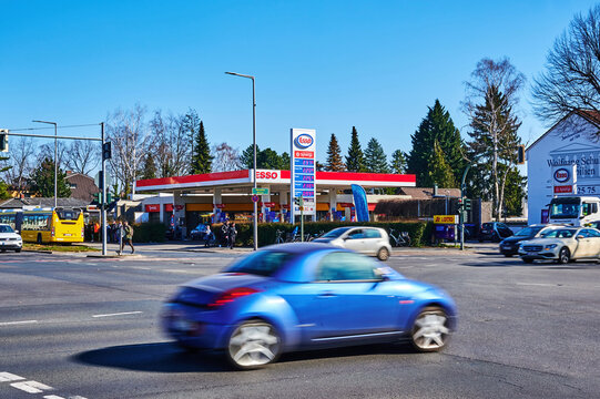 Berlin, Germany - March 11, 2022: View to an Esso Group gas station and a blurred car in the foreground.
