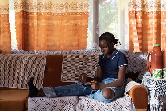 Portraits of teenager relaxing in a rural sitting room 