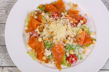 Caesar salad with salmon and parmesan