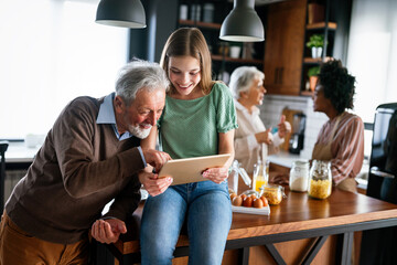 Portrait of happy multigeneration, multiethnic family having fun in kitchen at home