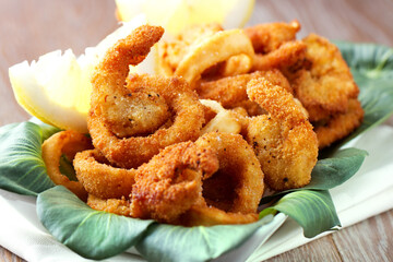 Fried squid rings breaded with lemon on a plate