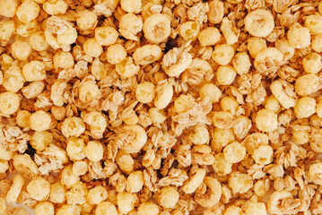 Dry muesli with cornflakes, nuts and raisins as texture background