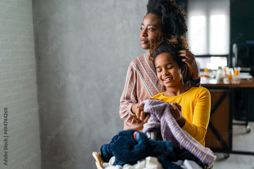 Wall mural happy multiethnic teenage children are smiling while do household with mother at home.