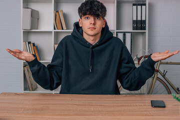 teenage boy at desk with puzzled expression
